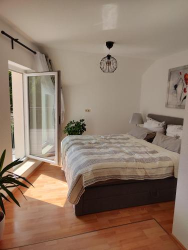a bedroom with a large bed and a window at Ferienwohnung zur alten Post in Pirna