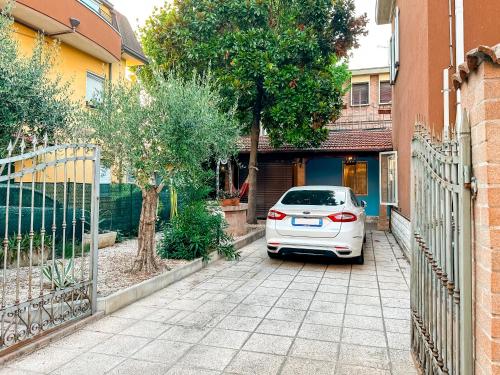 a white car parked in front of a house at Casa Quarti in Rimini