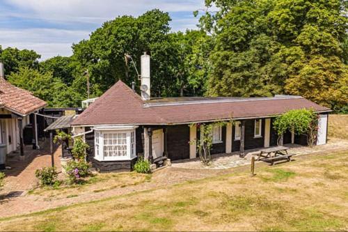 a small house with a picnic table in a yard at Unique English Heritage Escape in *Bembridge* IOW in Bembridge