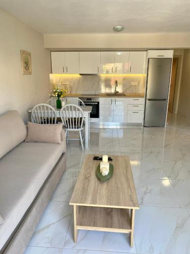 a living room with a couch and a table at Arian Apartments in Argostoli