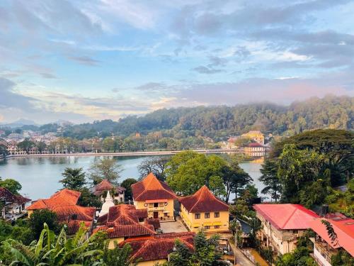 a view of a town with a river and buildings at The Glen Kandy in Kandy