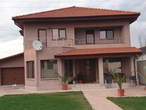 a large house with a dog sitting in front of it at Casa Loredana in Mangalia