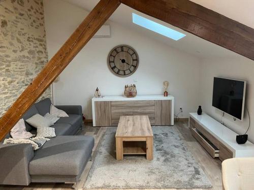 a living room with a couch and a table at Loft style industriel in Bagnols-sur-Cèze
