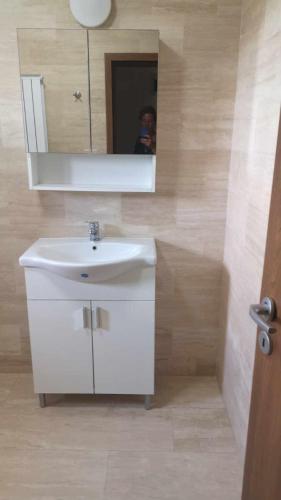 a bathroom with a white sink and a mirror at Casa Loredana in Mangalia