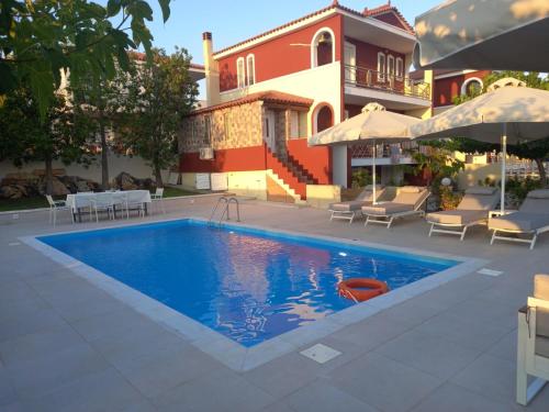 a swimming pool in front of a house at Villa Evàlia - Private Villa With Pool -Malakonda ,Eretria ,Greece in Eretria