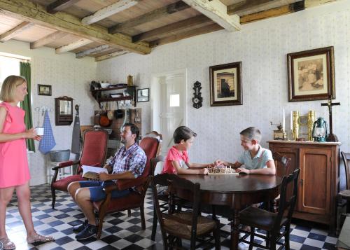 a group of people sitting around a table playing chess at Barak de Vinck in Ypres