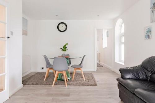 a living room with a table and chairs at Lovely 3 bedroom flat in North London in London