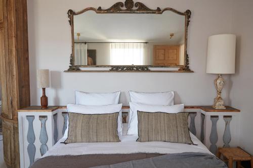 a bedroom with a bed with a mirror on the wall at Maisons 322 - Maison La Lumineuse in Le Bois-Plage-en-Ré