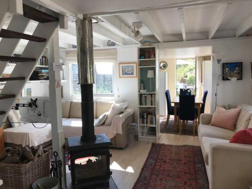 a living room with a wood burning stove in it at Quirky cosy rural hideaway in Swindon