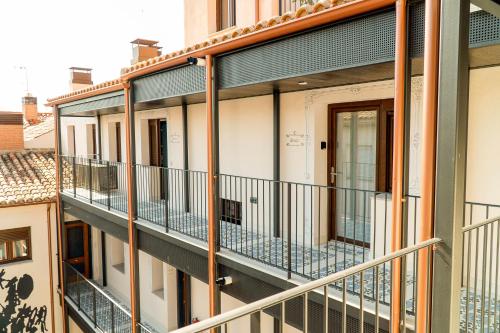 an apartment building with balconies in a city at Cervantes 5 Collection Catedral - Alcántara in Toledo