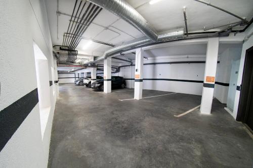 an empty parking garage with cars parked in it at Cervantes 5 Collection Catedral - Alcántara in Toledo