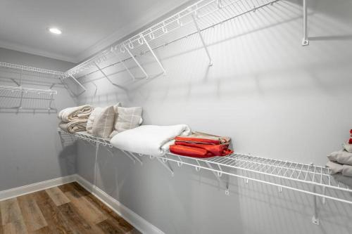 a closet with white walls and a shelf with towels at Lookout Escape - Top of Lookout Mountain in Lookout Mountain