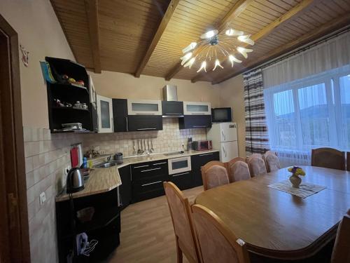 a kitchen and dining room with a table and a dining room at "Діброва" in Yaremche