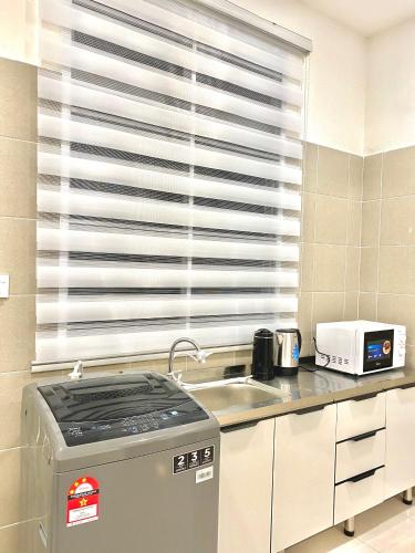 a kitchen with a sink and a window at HeyMuji Projector-Netflix-Darts-Near Lotus in Kluang