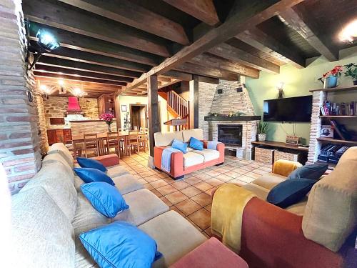 a large living room with couches and a fireplace at Agroturismo el Encuentro in Leza