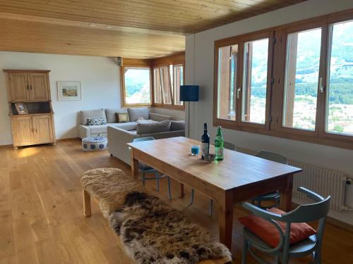uma sala de estar com uma mesa e um sofá em Chalet Seeblick em Sarnen