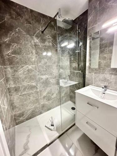 une salle de bain avec douche et lavabo dans l'établissement Superbe appartement neuf - Plage à 5 min à pied, à Nice