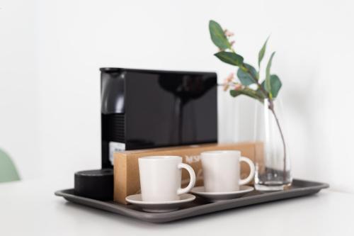 a tray with two coffee cups and a vase at Amazing Beachfront Property CASA CORINA I in El Médano