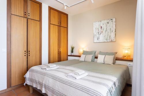 a bedroom with a large bed with two towels on it at Amazing Beachfront Property CASA CORINA I in El Médano