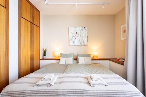 a bedroom with a bed with two towels on it at Amazing Beachfront Property CASA CORINA I in El Médano