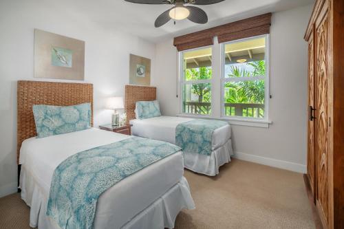 a bedroom with two beds and a window at Pili Mai 9G in Koloa