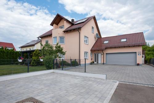 a large pink house with a garage at Ferienwohnung Regel in Lauingen