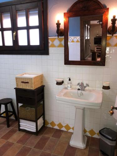 La salle de bains est pourvue d'un lavabo et d'un miroir. dans l'établissement Casa de Piedra la Loma, à Calar de la Santa