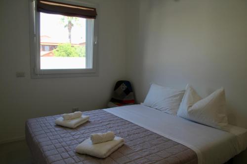 a bedroom with a bed with two towels on it at Le due sorelle - LUCI in Civitanova Marche