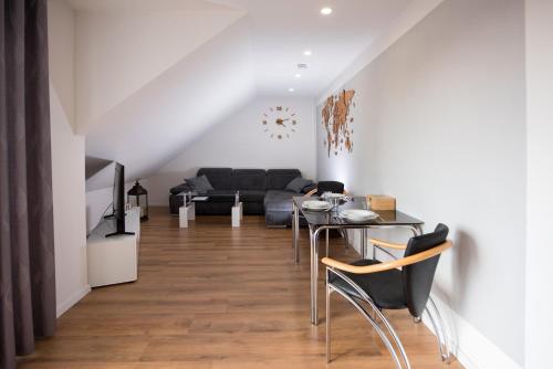 a living room with a couch and a table and chairs at Ferienwohnung Regel in Lauingen