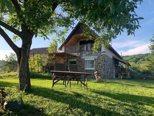 a house with a picnic table in front of it at A Vidám Vándor Vendégház in Zalaszántó