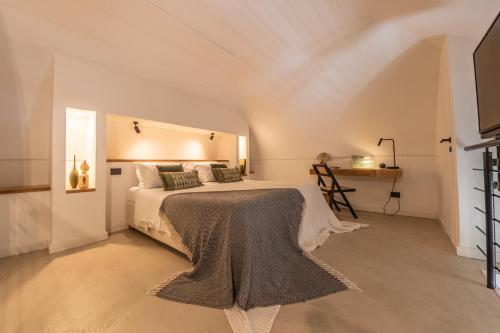 a bedroom with a bed with a blanket on it at ES Suites in Naples