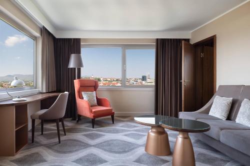 a living room with a couch and a chair and a table at The Westin Zagreb in Zagreb