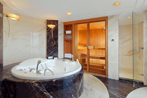 a bathroom with a bath tub and a shower at The Westin Zagreb in Zagreb