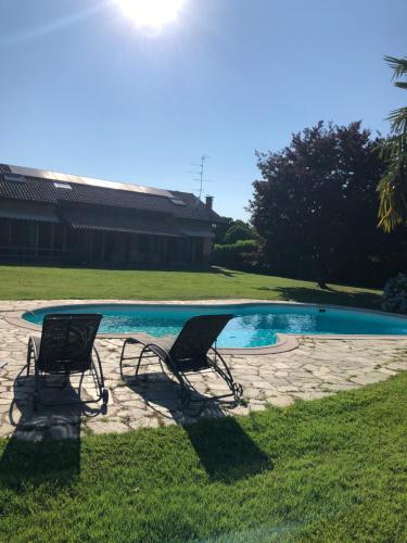 two chairs sitting in front of a swimming pool at IL SALICE in Novara