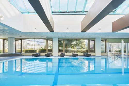 a swimming pool in a building with windows at Sheraton Grande Tokyo Bay Hotel in Urayasu