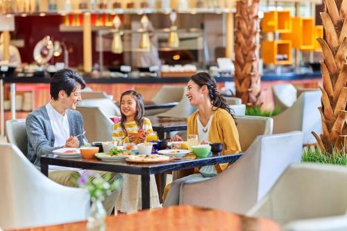 a group of people sitting at a table in a restaurant at Sheraton Grande Tokyo Bay Hotel in Urayasu