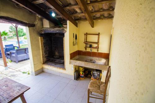 a patio with a fireplace and a table and chairs at Charming villa with A/C and WIFI in Pollença