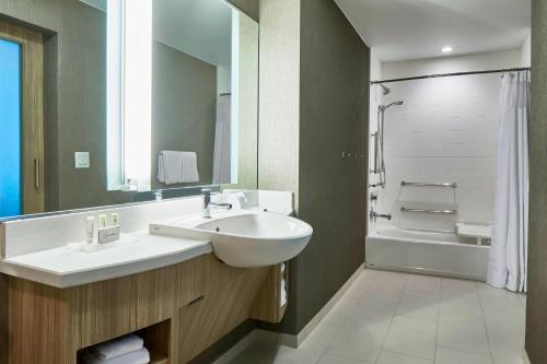 a bathroom with a white sink and a shower at SpringHill Suites by Marriott Nashville Downtown/Convention Center in Nashville
