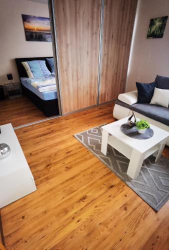a living room with a couch and a table at Ferienwohnung im Starenweg in Blankenburg