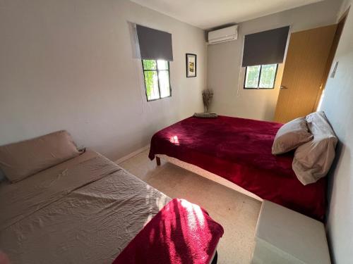 a bedroom with two beds and a couch at Finca el Paradisus in Carmona