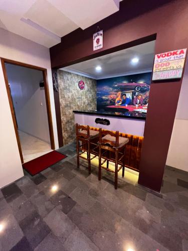 a bar in a room with a table and chairs at Villa Munjul Indah - Majalengka in Jatipamor