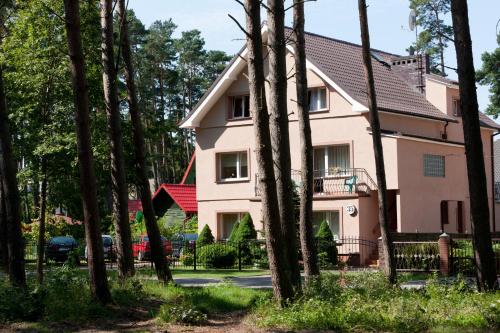 a house with a lot of trees in front of it at Janina in Pobierowo