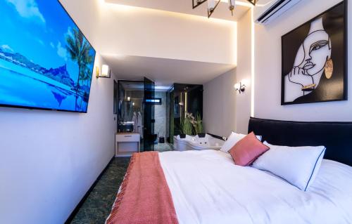 a bedroom with a white bed and a bathroom at South Star Suites in Eilat