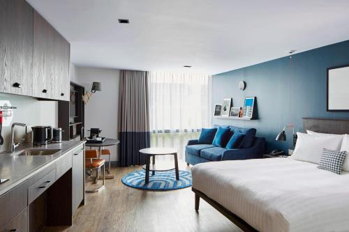 a hotel room with a bed and a kitchen at Residence Inn by Marriott London Kensington in London