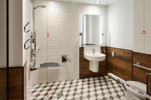 a bathroom with a sink and a shower and a toilet at Residence Inn by Marriott London Kensington in London