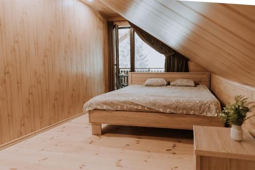 a bedroom with a bed and a window at Holiday home Migliņas in Kaugurmuiza