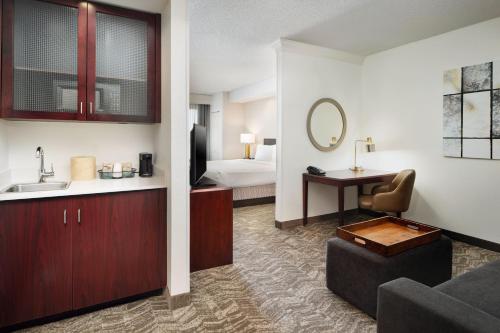 a hotel room with a sink and a bed at SpringHill Suites Boulder Longmont in Longmont