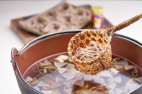 a pot of soup with a basket on top of it at Courtyard by Marriott Hakuba in Hakuba