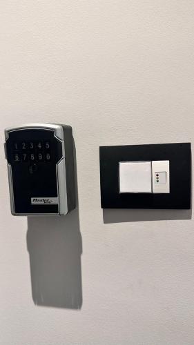 an electronic device is attached to a wall at Centro Storico Caruggi 2min Acquario Pellicceria Superior Loft Palazzo Rolli in Genova