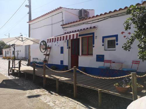 a house with a wooden deck in front of it at A Casa do Mestre Lau - no coração do Alentejo in Terena